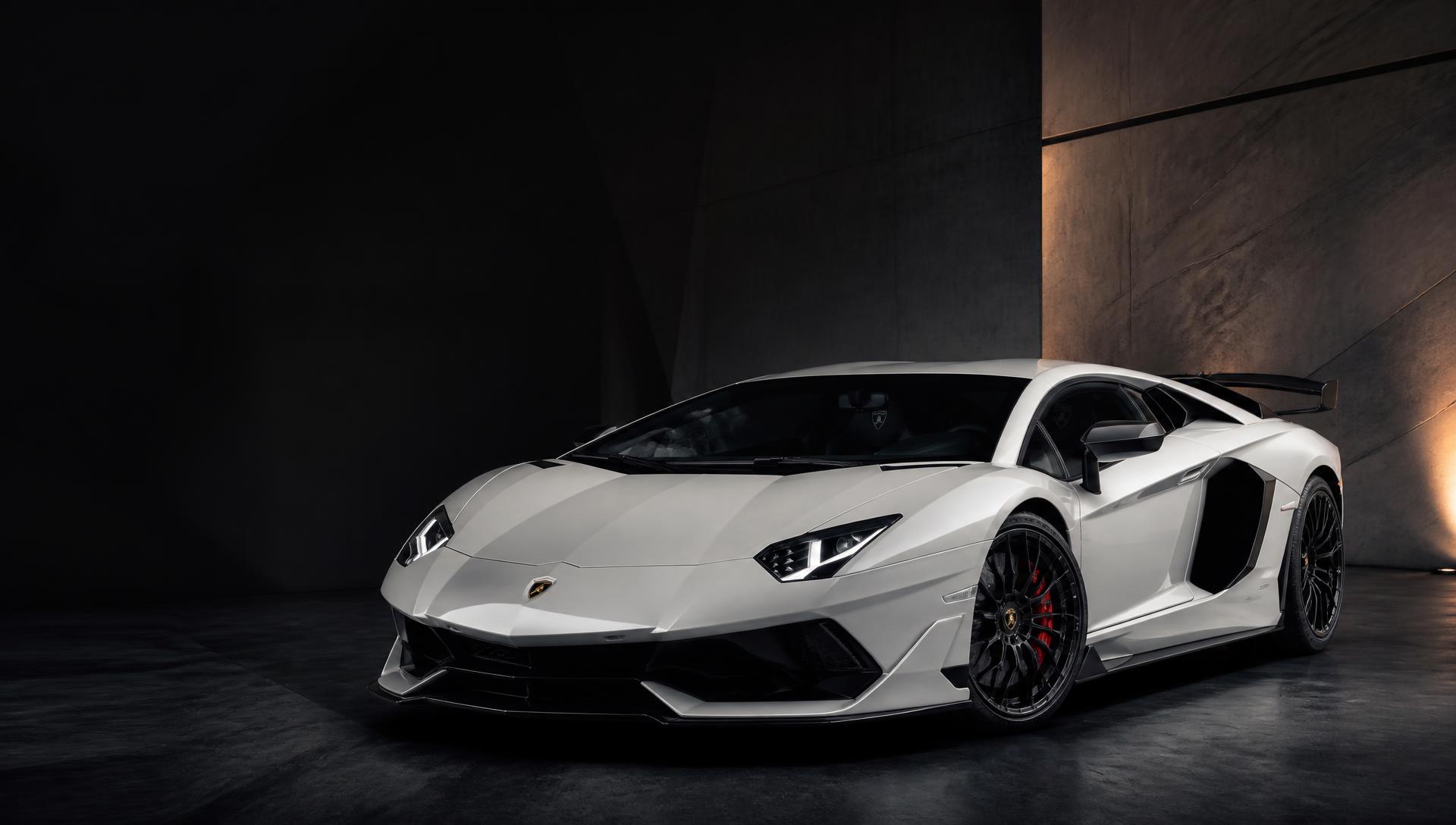 Pearl white Lamborghini Aventador SVJ in a dark architectural space, bodywork finished to the OnPoint Standard
